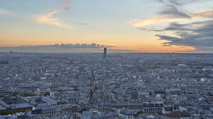 Panoramic cityscape with a skyscraper in Paris at sunset, France.