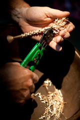 making jewellery, macro photo of hands holding cast golden parts for jewelry