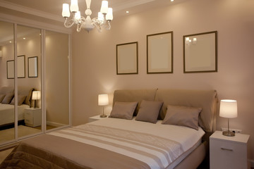 epmty minimalistic interior background, bedroom of modern apartment with big mirrors, double bed, lights on