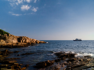 Afternoon sea view, rocks, boat in the island	