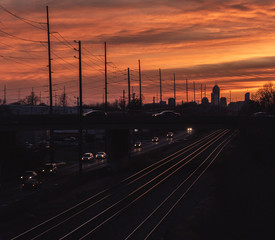 A view of train tracks leading to  downtown Indianapolis from the East side at sunset