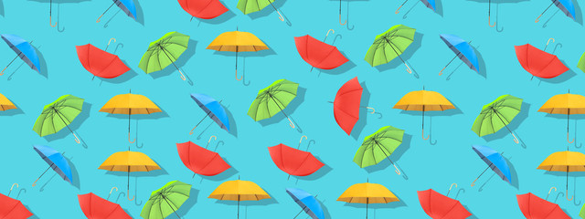 Multi-colored umbrellas pattern on blue background.