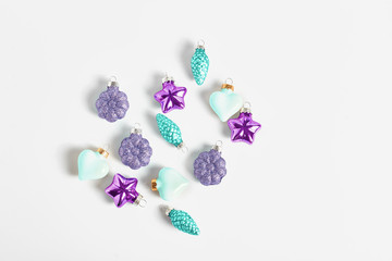 New year concept. beautiful Christmas toys turquoise and purple on white background. flat lay, space for text
