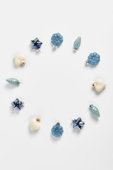 holiday wreath. Christmas decor in the form of cone, heart, and stars in blue color on a white background. vertical frame, flat lay, space for text