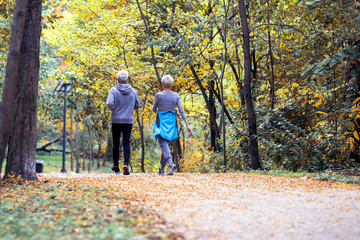 Fototapeta premium Mature couple man and woman jogging in the park