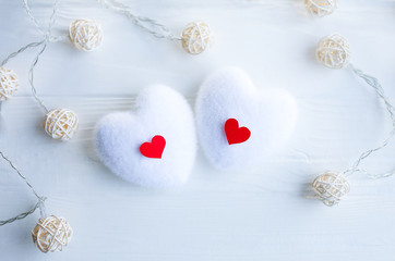 Red and white hearts on wooden background. Saint Valentine's day concept. Love and romantic photo. Postcard for holiday. Small rustic lights.