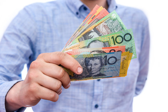 Man holding australian dollar banknotes isolated on white