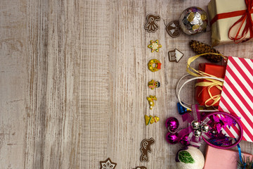 Frame of gift boxes and fir branches on wooden table. Christmas celebration