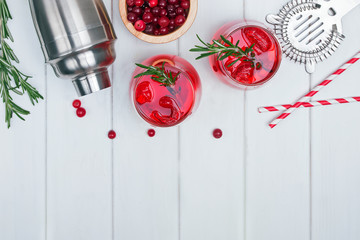 Cranberry cocktail with rosemary and ice.