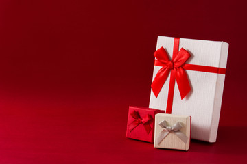 White and red gift boxes on red background. Copy space