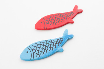 Colorful wooden fish on white background