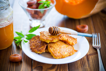 tasty fried sweet pumpkin pancakes with honey