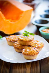 baked sweet pumpkin muffins with dried apricots inside,