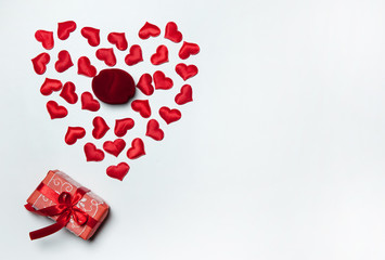 The Concept Of Valentine's Day. Velvet jewelry gift box and red hearts on white background. Free space for your text.
