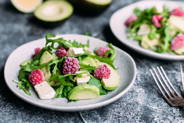 Salad with arugula, avocado, raspberries and brie cheese