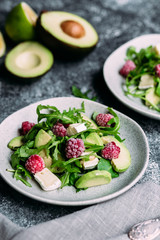 Salad with arugula, avocado, raspberries and brie cheese