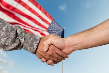 Close up business agreement handshake on background