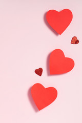Valentine's day frame composition. Red hearts on pastel pink background. Top view, flat lay, copy space