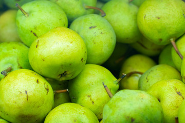 Green pears background on the market