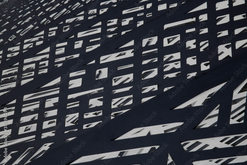 Poster metal fence in sunlight resembling abstract modern industrial architecture. grid structure with ligh