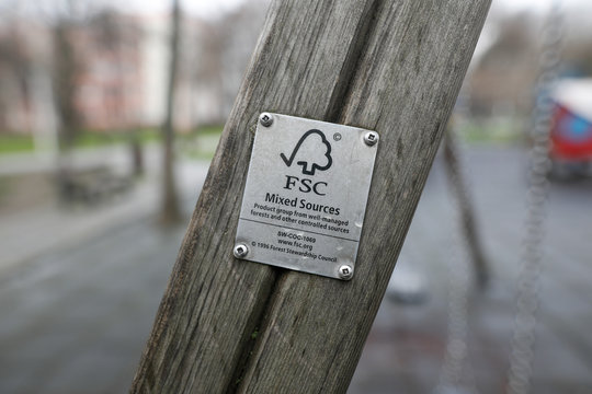 etails of a FSC (Forest Stewardship Council) logo tag on a piece of wood on a kids playground.