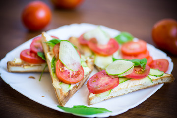 tasty sandwich with curd paste, fresh cucumbers and tomatoes