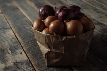 onions in the basket, the onion is white, .onion wooden background
