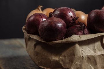 onions in the basket, the onion is white, .onion wooden background