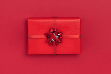 New Year and Christmas composition. Gift box on red background. Top view, flat lay