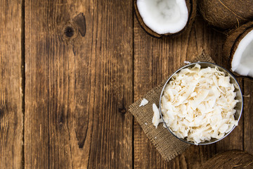 Obraz na płótnie Canvas Some healthy Coconut Chips (selective focus; close-up shot)