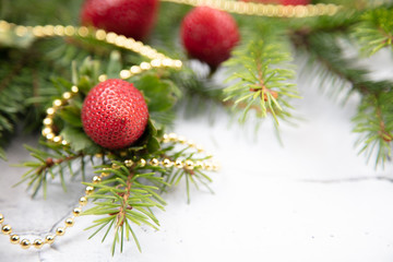 A beautiful sprig of spruce decorated with strawberries. Fresh strawberries close-up, decoration for the Christmas tree.