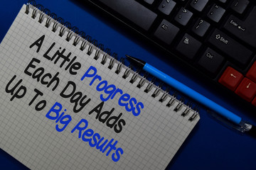 Obraz premium A Little Progress Each Day Adds Up to Big Results write on a book isolated on Office Desk