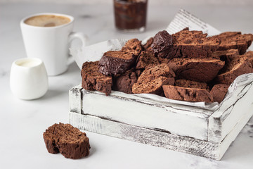 Traditional Italian homemade biscotti cookies or cantuccini with chocolate in a light grey wooden...