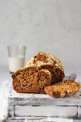 Butter-free and sugar-free banana bread with almond on a light grey wooden tray. Ideas and recipes for healthy diet breakfast. Selective focus.