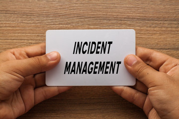Incident Management written on white card holding with two hands