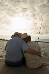 Romantic Senior Couple Fishing At The Beach
