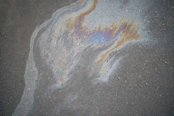 Oil slick on the asphalt road background