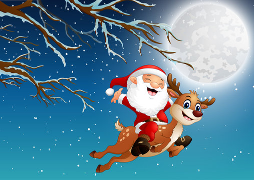 Santa claus riding a reindeer over the christmas night