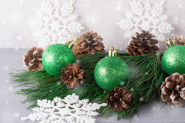 Christmas card. Fir tree branch with Christmas toys and snow.