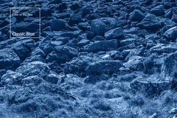 Naklejka premium Color of the year 2020 concept, classic blue colored trend for your design. Copy space. COY2020. Ancient mountain rock landscape in Scotland. Beautiful scottish backdrop