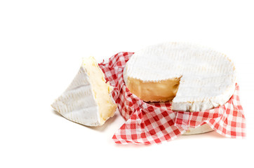 Camembert cheese and slice in wooden box on white background