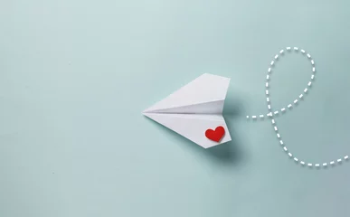 Poster paper love airplane on color background..The concept of a love message. Valentine's Day. Declare love. Love note. © PANDA