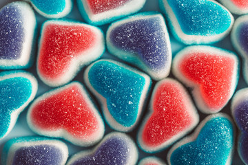 Tasty chewing marmalade in the shape of hearts, candy background