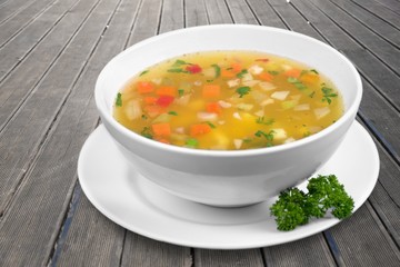 Bowl of delicious vegetables soup on table