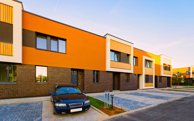 Apartment town house residential building and car parked reflex