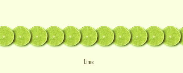 sliced green lime over yellow background, panoramic image