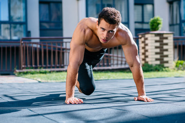 Fototapeta premium Handsome healthy male taking break after fitness workout and exercising.