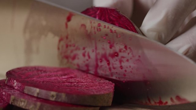 Cutting beet with sharp chef knife macro shot, cooking process, preparing ingredients for Tar Tar, slow motion, shot on Red Weapon Helium
