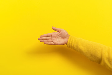 palm with place for text over yellow background, female hand with advertising space