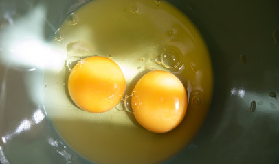Two Egg Yolks In A Bowl On A Sunny Day. Close-Up. Macro.